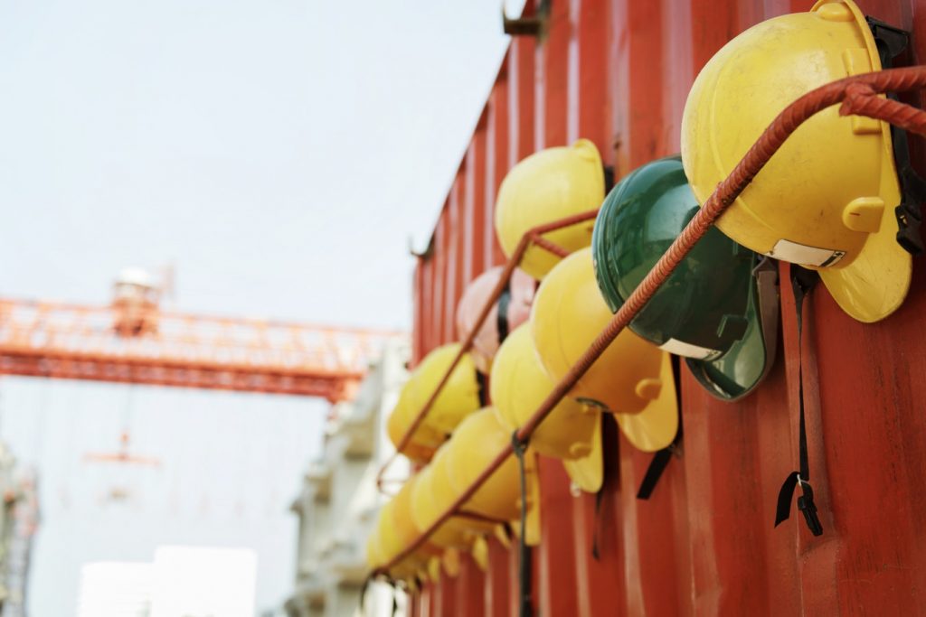 Hardhats hanging on an orange trailer